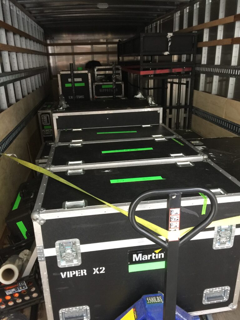 Full box truck of band tour supplies delivering to tour location